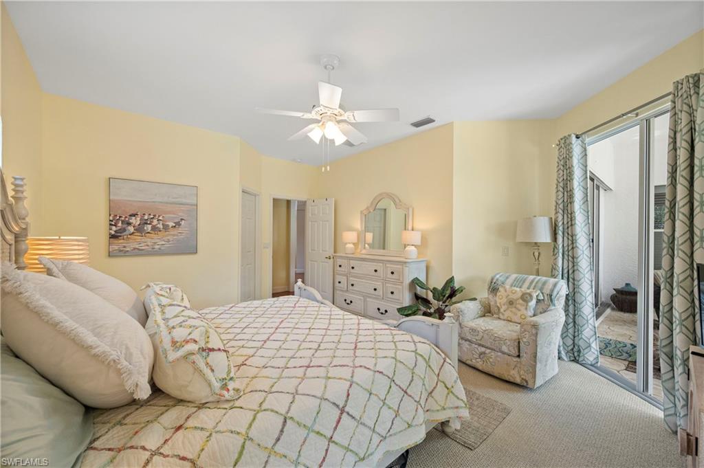 1742 Marsh Run Naples, FL 34109 - Photo 20 of 31 a bedroom with a bed and a chandelier