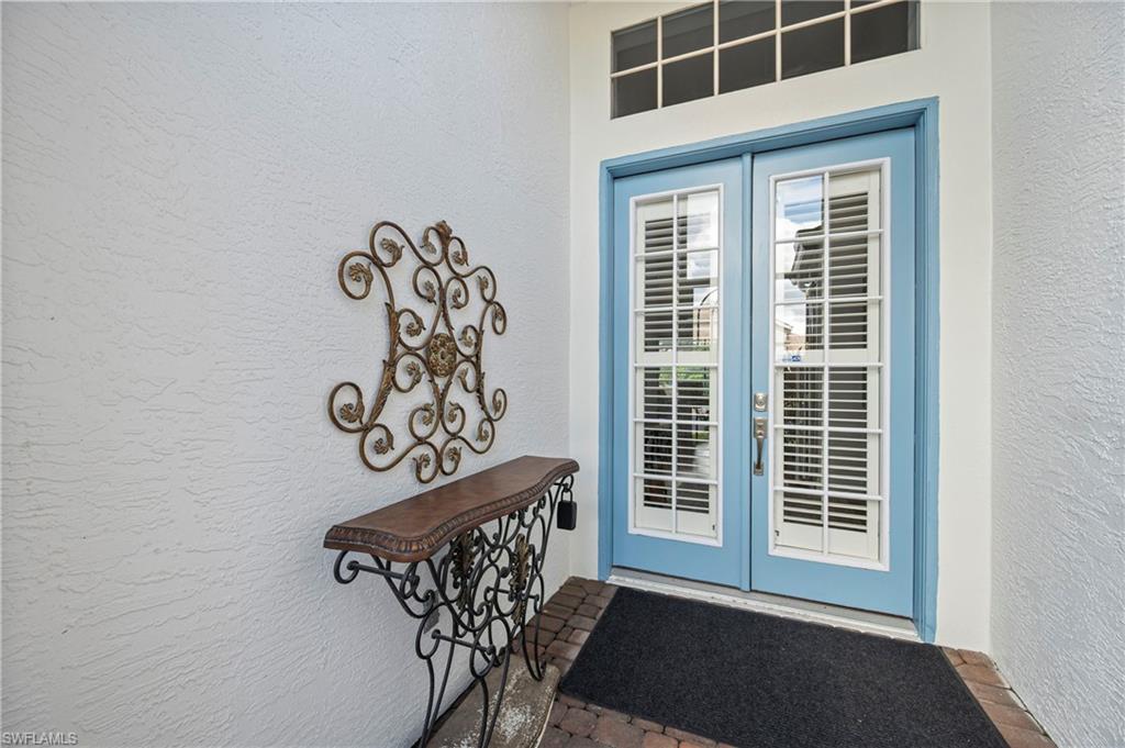 1742 Marsh Run Naples, FL 34109 - Photo 2 of 31 a view of a door and chair in the room