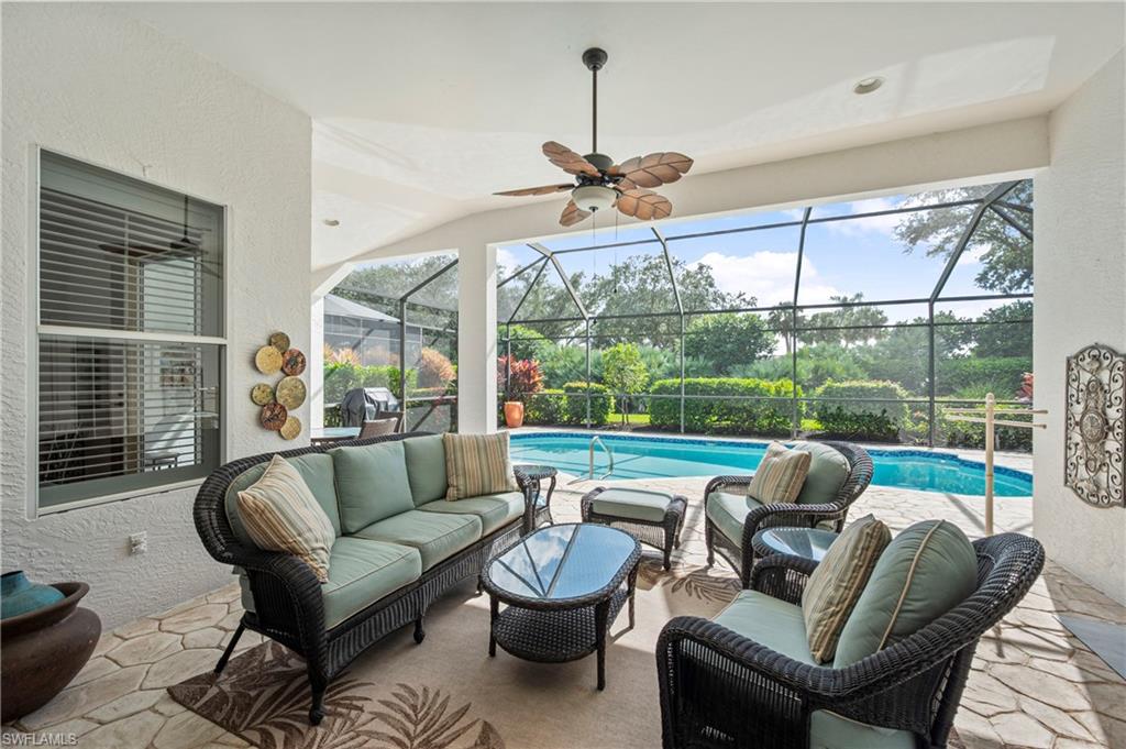 1742 Marsh Run Naples, FL 34109 - Photo 23 of 31 a living room with furniture and a floor to ceiling window