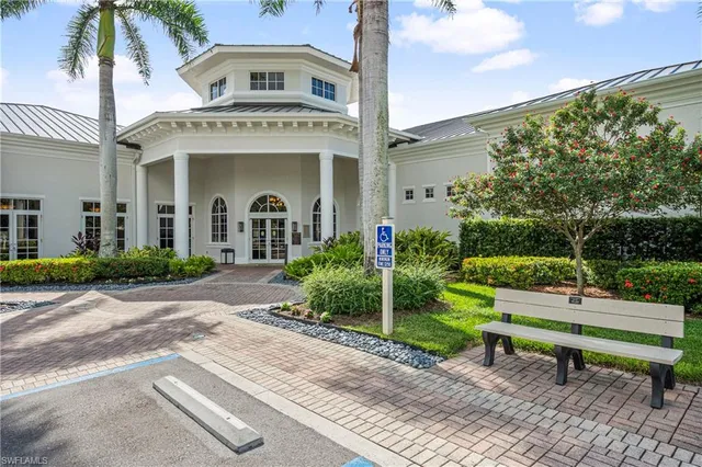 a patio with a table and chairs under an umbrella