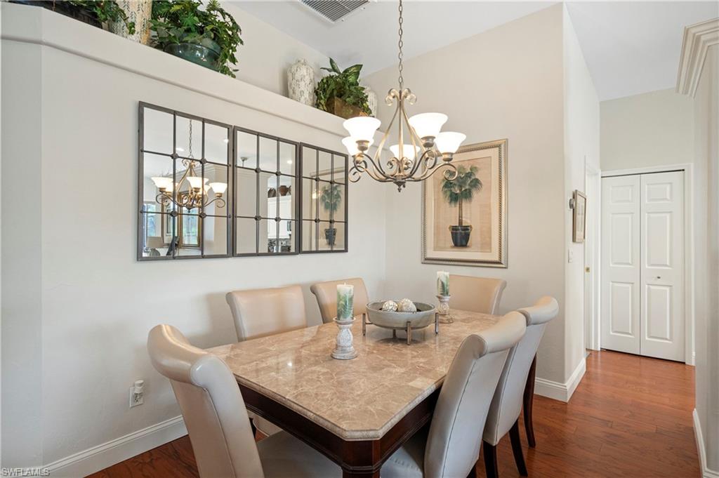 1742 Marsh Run Naples, FL 34109 - Photo 5 of 31 a view of a dining room with furniture wooden floor and chandelier
