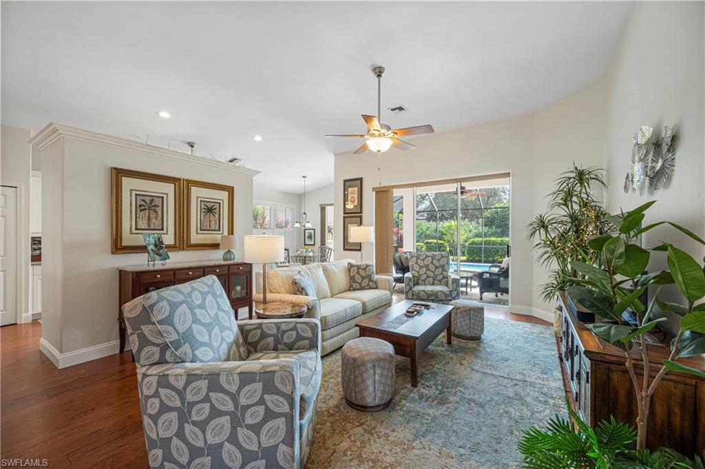 1742 Marsh Run Naples, FL 34109 - Photo 7 of 31 a living room with furniture a chandelier and a window