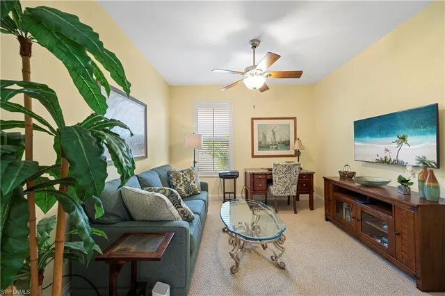 a living room with furniture a chandelier and a rug