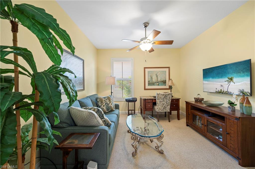 1742 Marsh Run Naples, FL 34109 - Photo 9 of 31 a living room with furniture a chandelier and a rug