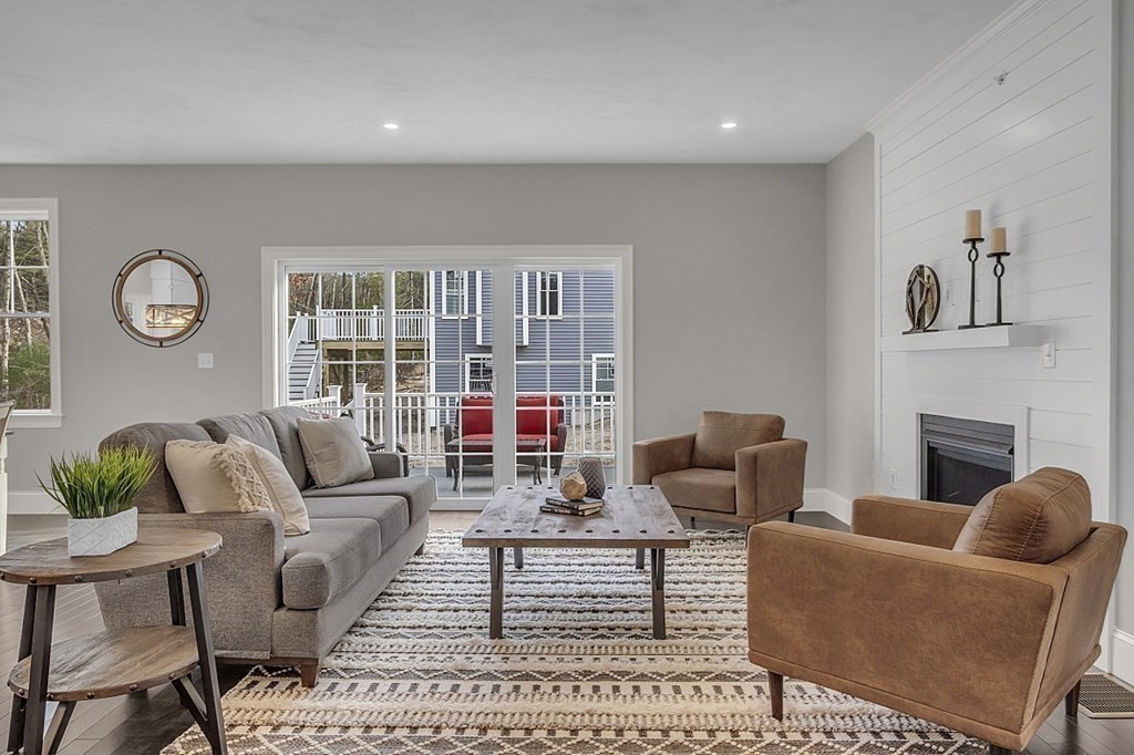 5 Boot Shop Road, Unit 31 Upton, MA 01568 - Photo 12 of 28 a living room with furniture and a fireplace