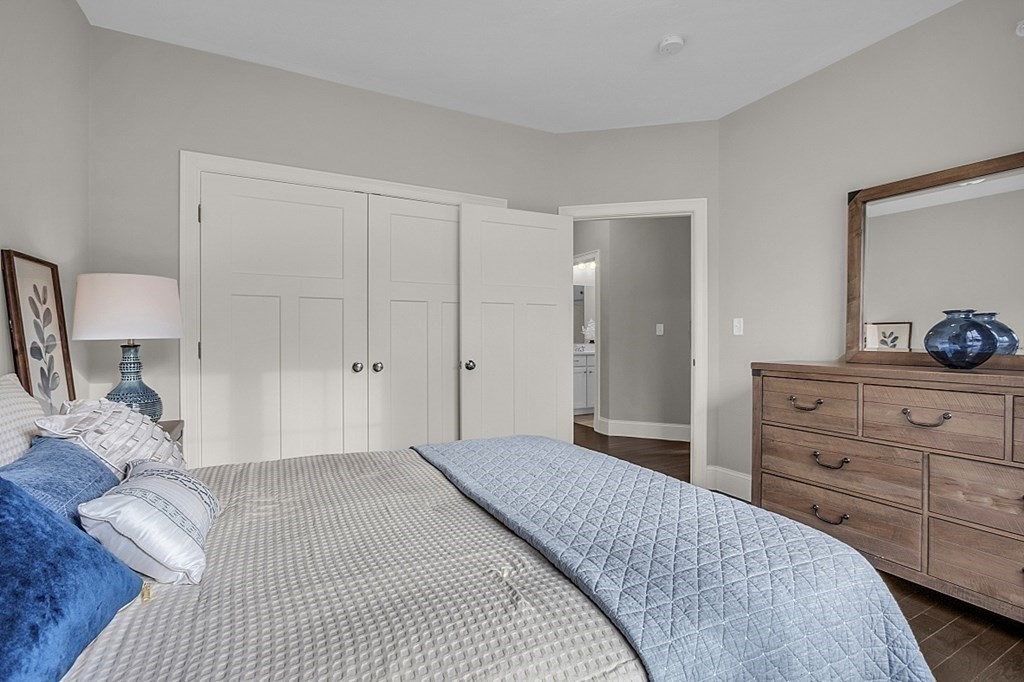 5 Boot Shop Road, Unit 31 Upton, MA 01568 - Photo 23 of 28 a bedroom with a bed and a dresser in it