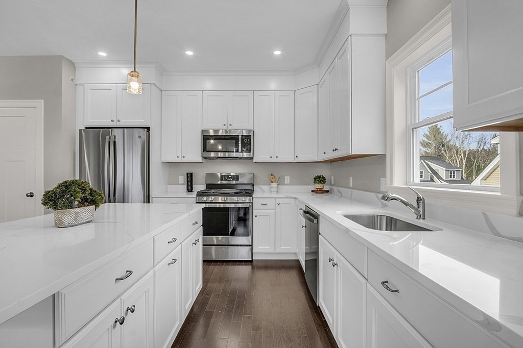 5 Boot Shop Road, Unit 31 Upton, MA 01568 - Photo 6 of 28 a kitchen with white cabinets and stainless steel appliances