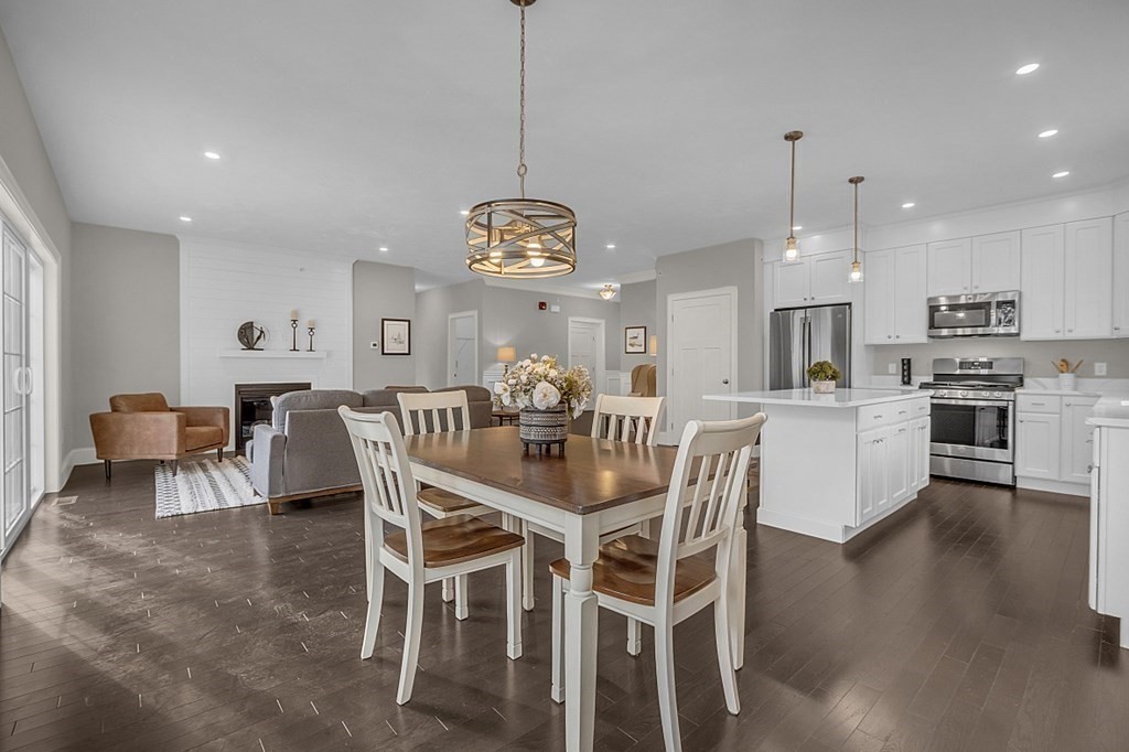 5 Boot Shop Road, Unit 31 Upton, MA 01568 - Photo 10 of 28 a view of a dining room and livingroom with furniture wooden floor a chandelier