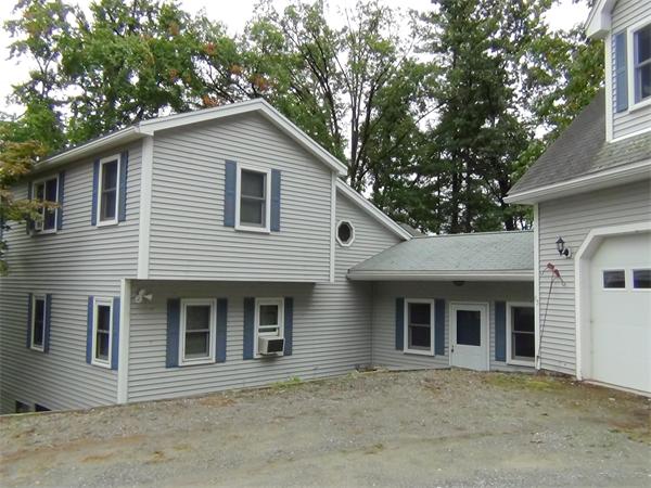 65 Spring Street Lunenburg, MA 01462 - Photo 1 of 7 a front view of a house with a tree