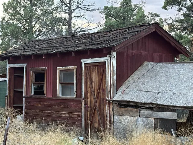 a view of a wooden house with a yard