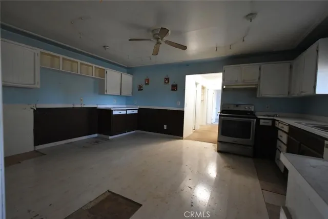 a kitchen with stainless steel appliances a refrigerator a sink a stove and cabinets