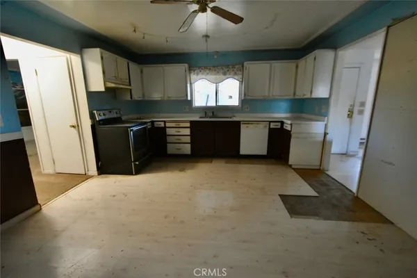 a kitchen with granite countertop a refrigerator and a sink