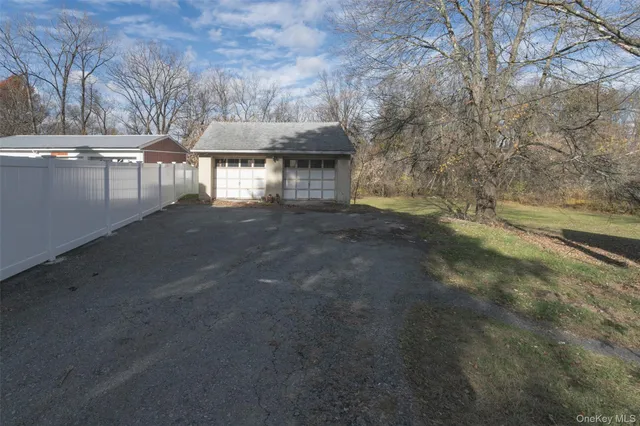 a view of a patio with a table and chairs under an umbrella