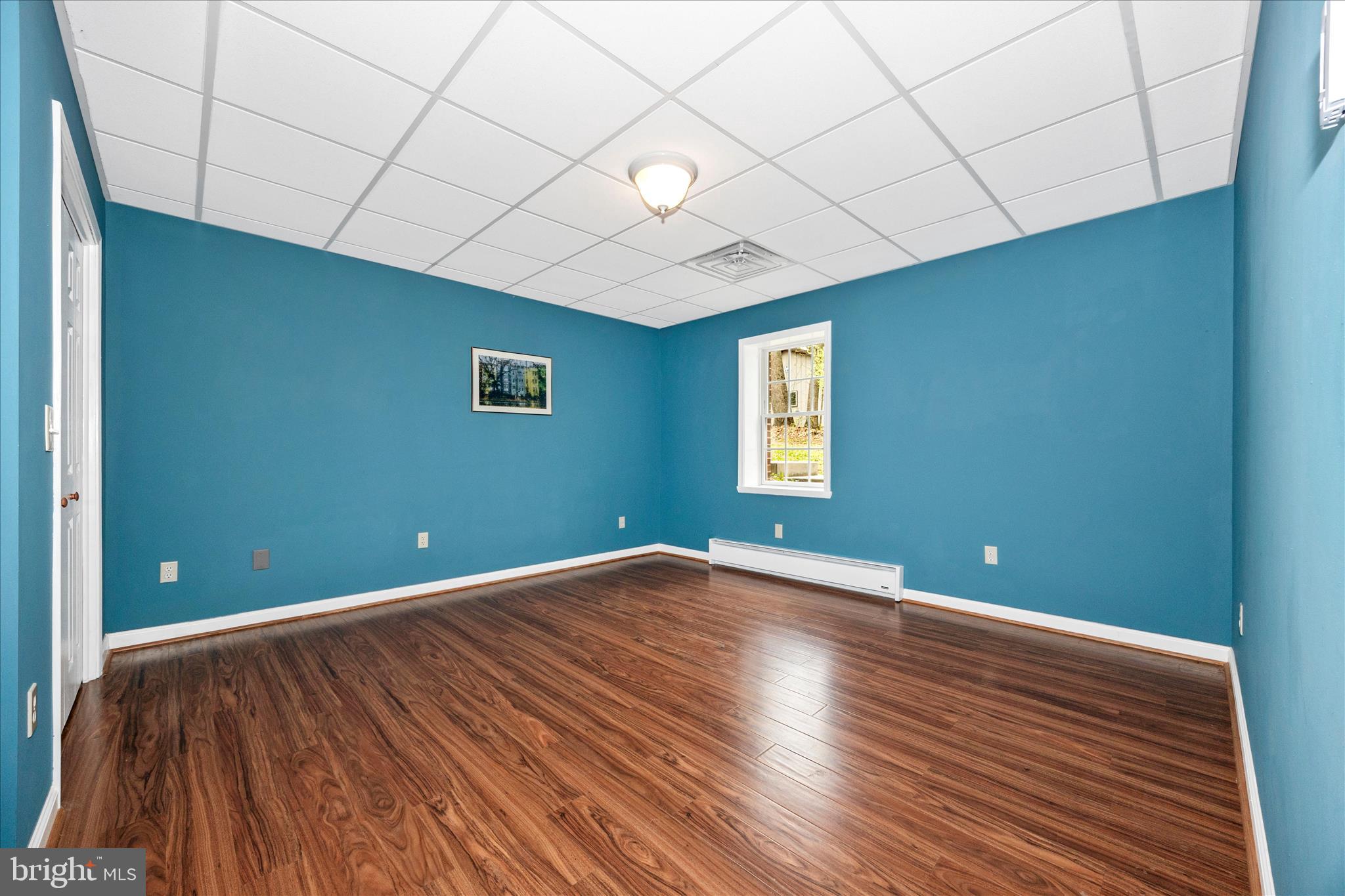 10393 Liberty Road Frederick, MD 21701 - Photo 13 of 47 a view of an empty room with wooden floor and a window