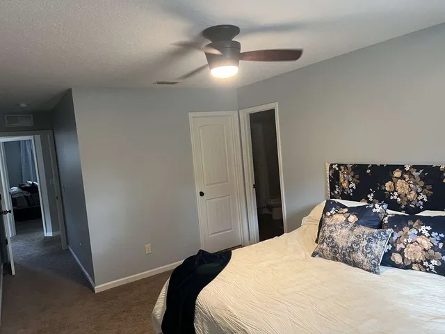 a room with a air conditioner and cabinets