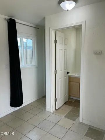 a view of a utility room with closet and mirror
