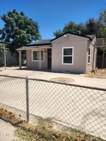 a backyard of a house with wooden fence
