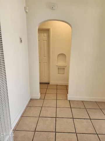a view of a livingroom with wooden floor and a white door