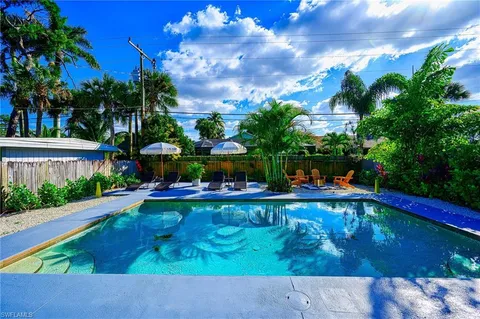 a swimming pool with outdoor seating and yard