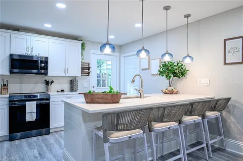 a kitchen with a table and chairs in it