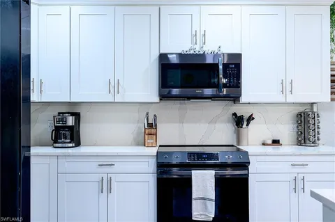 a kitchen with stainless steel appliances granite countertop a stove a microwave and cabinets