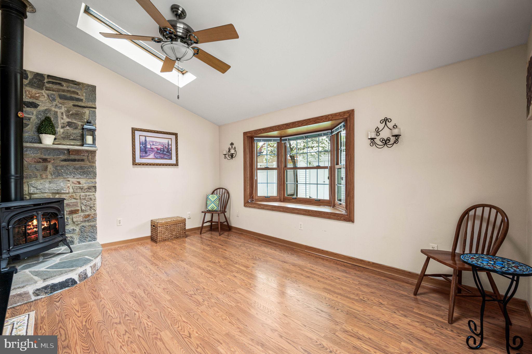 481 Maplewood Road Springfield, PA 19064 - Photo 12 of 31 a bedroom with furniture a fireplace and wooden floor