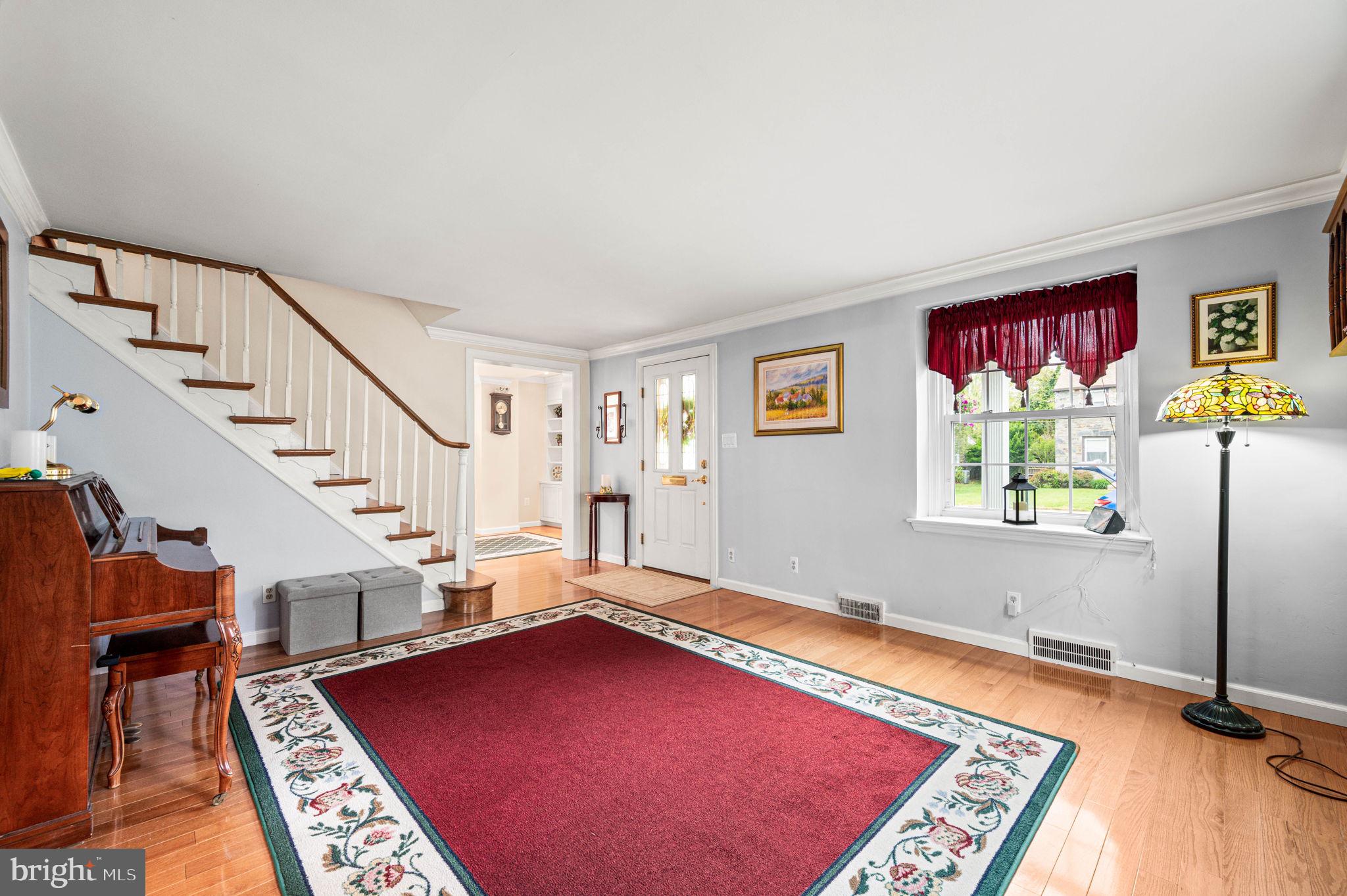 481 Maplewood Road Springfield, PA 19064 - Photo 4 of 31 a view of an empty room with wooden floor and paintings on the walls