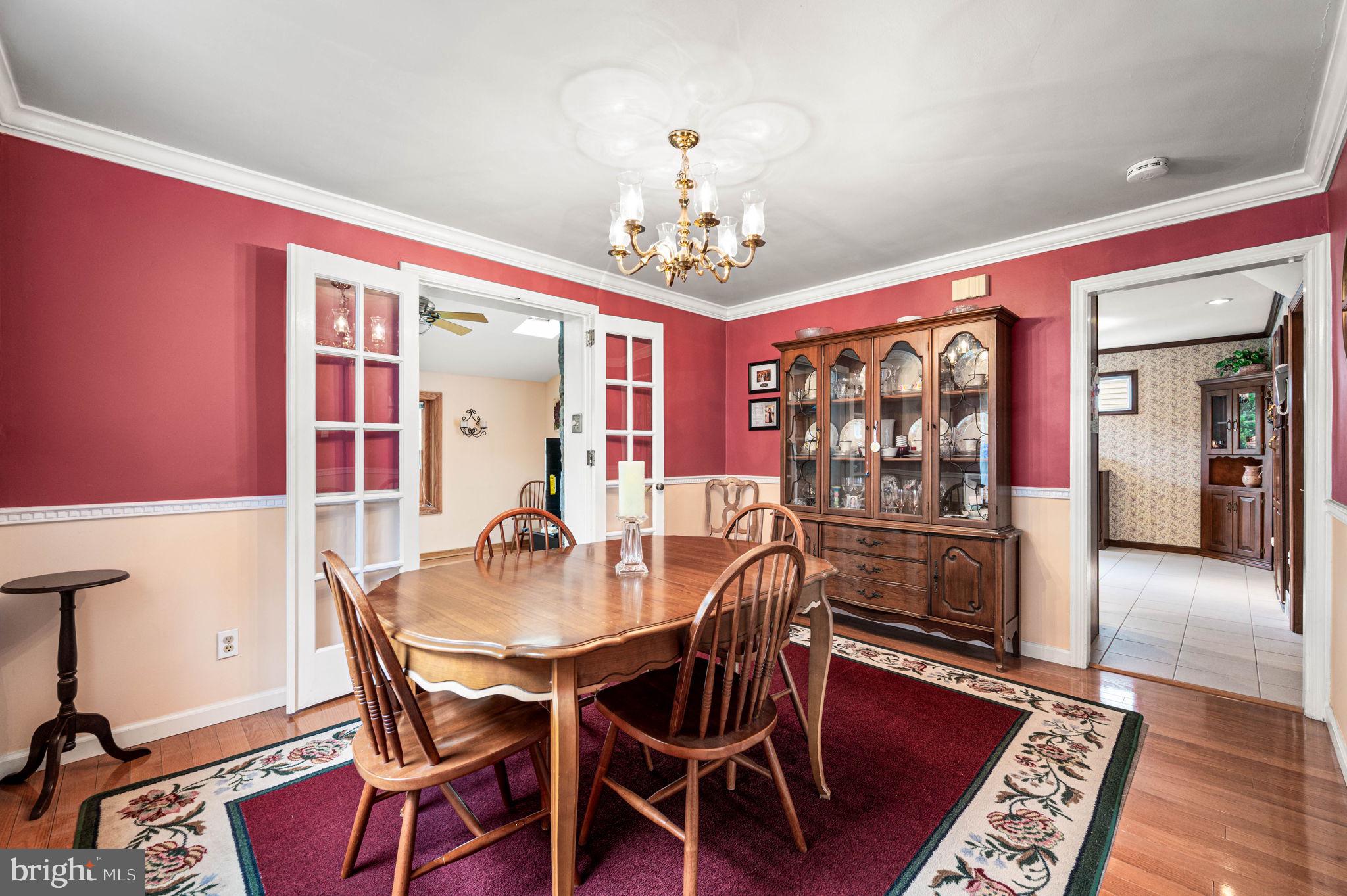 481 Maplewood Road Springfield, PA 19064 - Photo 7 of 31 a dining room with furniture a chandelier and wooden floor