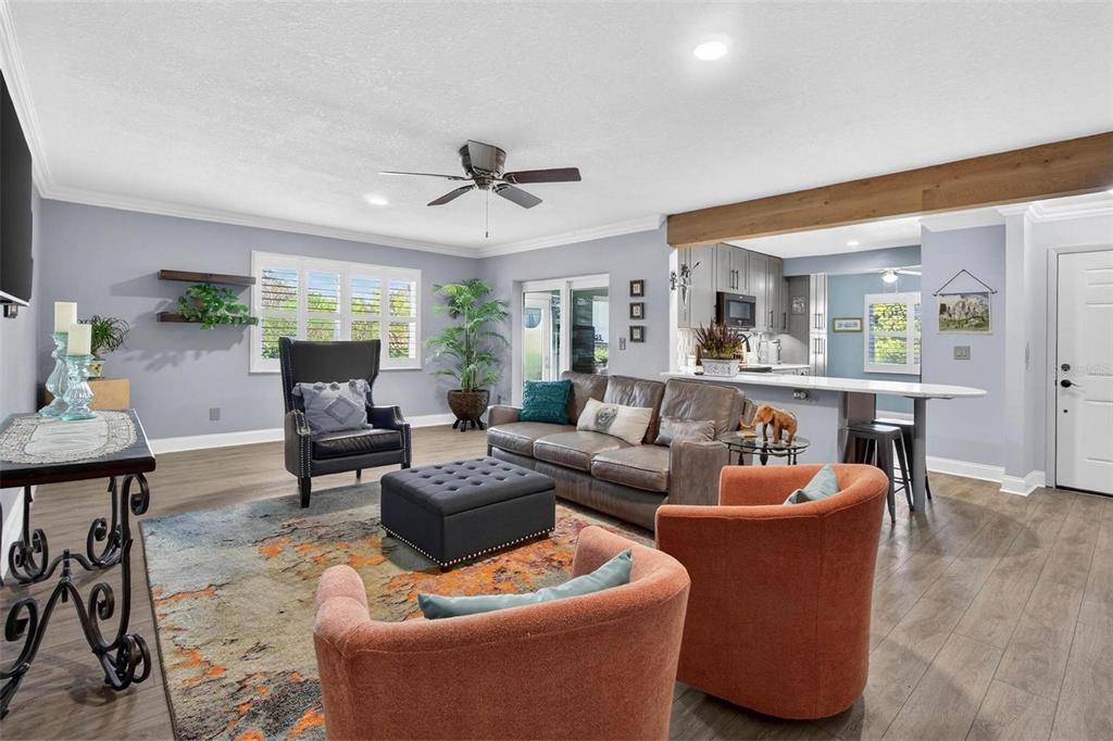 2811 Rampart Circle, Unit 2811 Clearwater, FL 33761 - Photo 13 of 30 a living room with furniture a ceiling fan a lamp and a flat screen tv