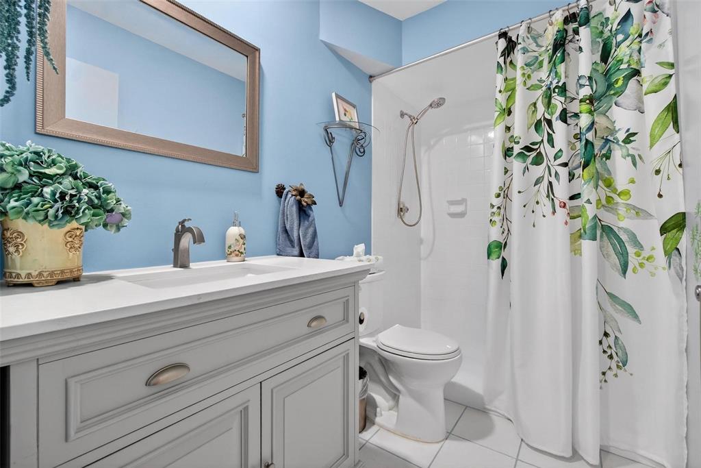 2811 Rampart Circle, Unit 2811 Clearwater, FL 33761 - Photo 16 of 30 a bathroom with a sink a toilet and a mirror