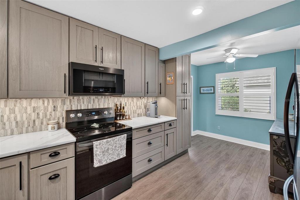 2811 Rampart Circle, Unit 2811 Clearwater, FL 33761 - Photo 6 of 30 a kitchen with granite countertop a sink a stove and cabinets