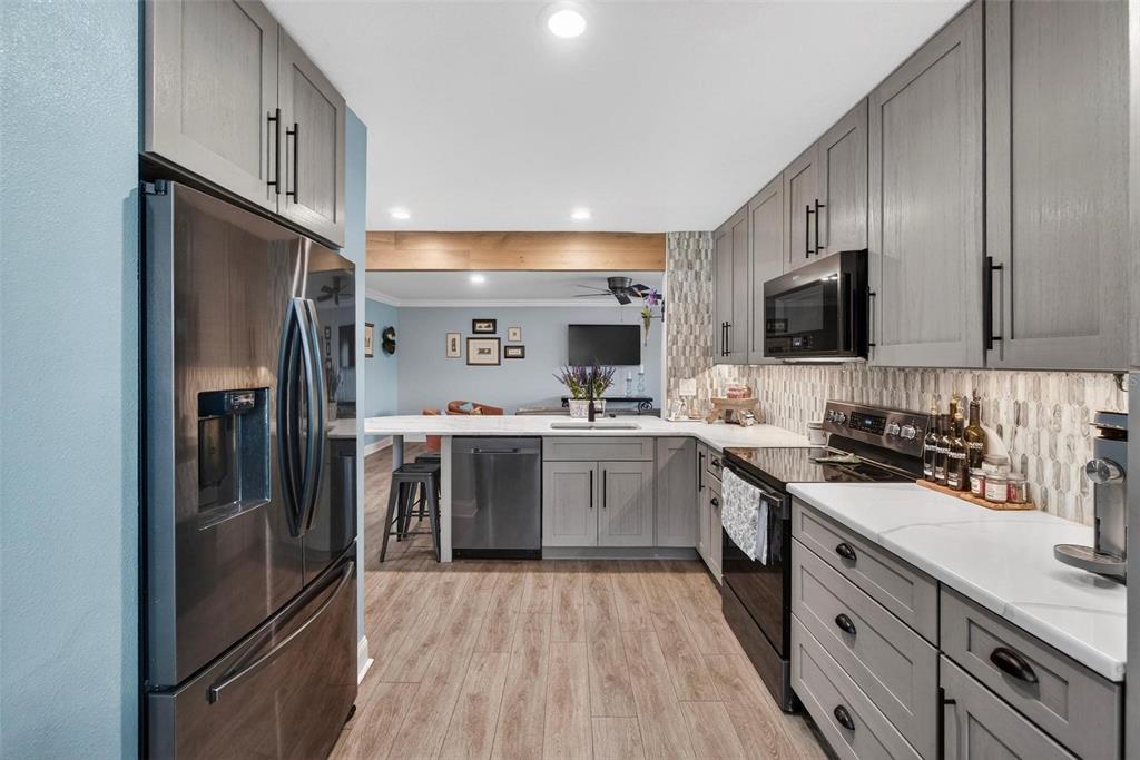 2811 Rampart Circle, Unit 2811 Clearwater, FL 33761 - Photo 7 of 30 a kitchen with a sink stainless steel appliances and cabinets