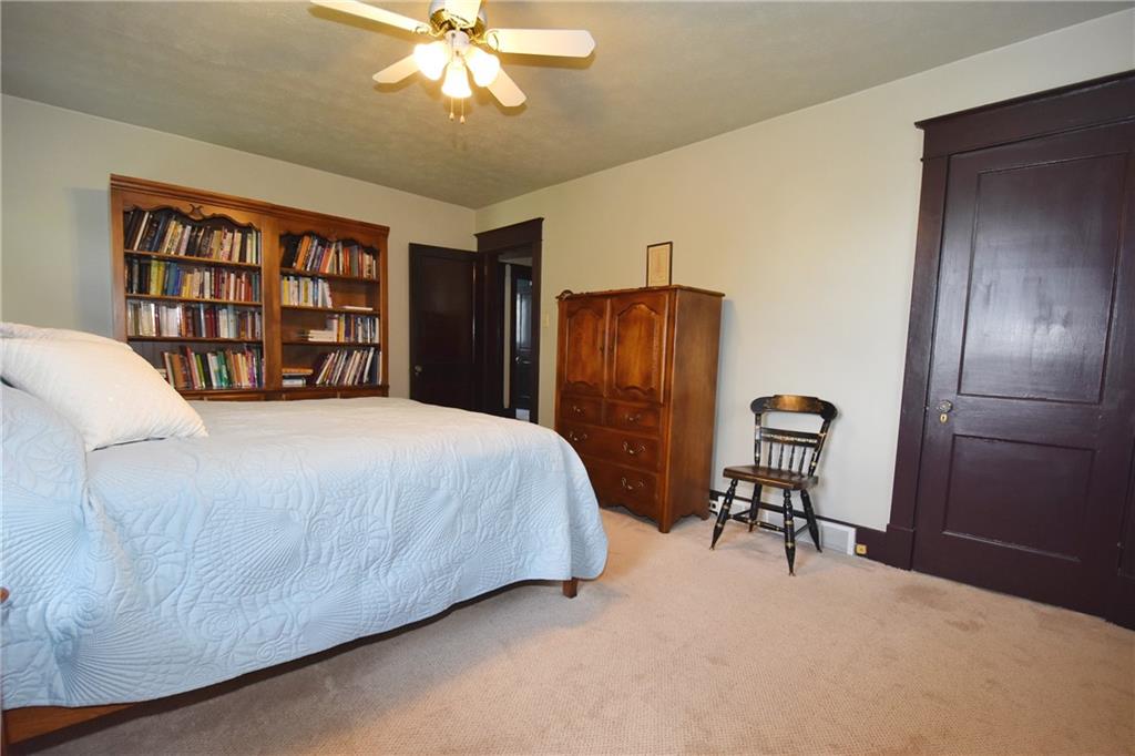 3325 Brownsville Road Pittsburgh, PA 15227 - Photo 18 of 30 a bed room with a bed and a chandelier