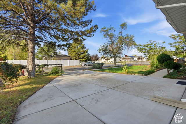 1127 Electra Lane Sandy, UT 84094 - Photo 22 of 27 Paved concrete driveway and walkway with established landscaping