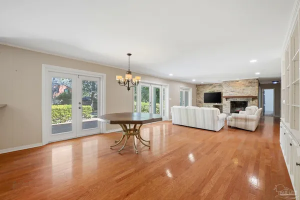 a view of a dining room with furniture wooden floor and chandelier