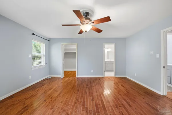 a view of empty room with wooden floor