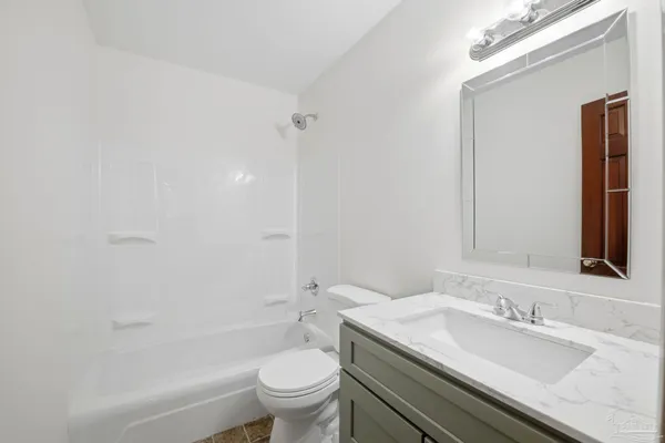 a bathroom with a sink toilet vanity and shower