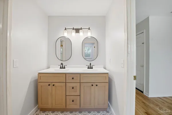 a bathroom with 2 sink and a mirror