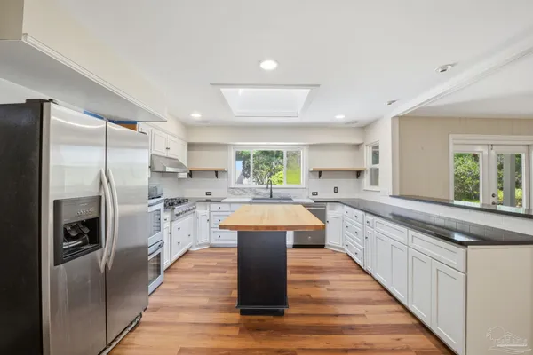 a kitchen with a stove sink and refrigerator