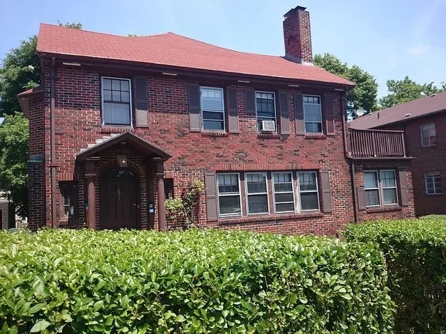 a brick house with a large windows