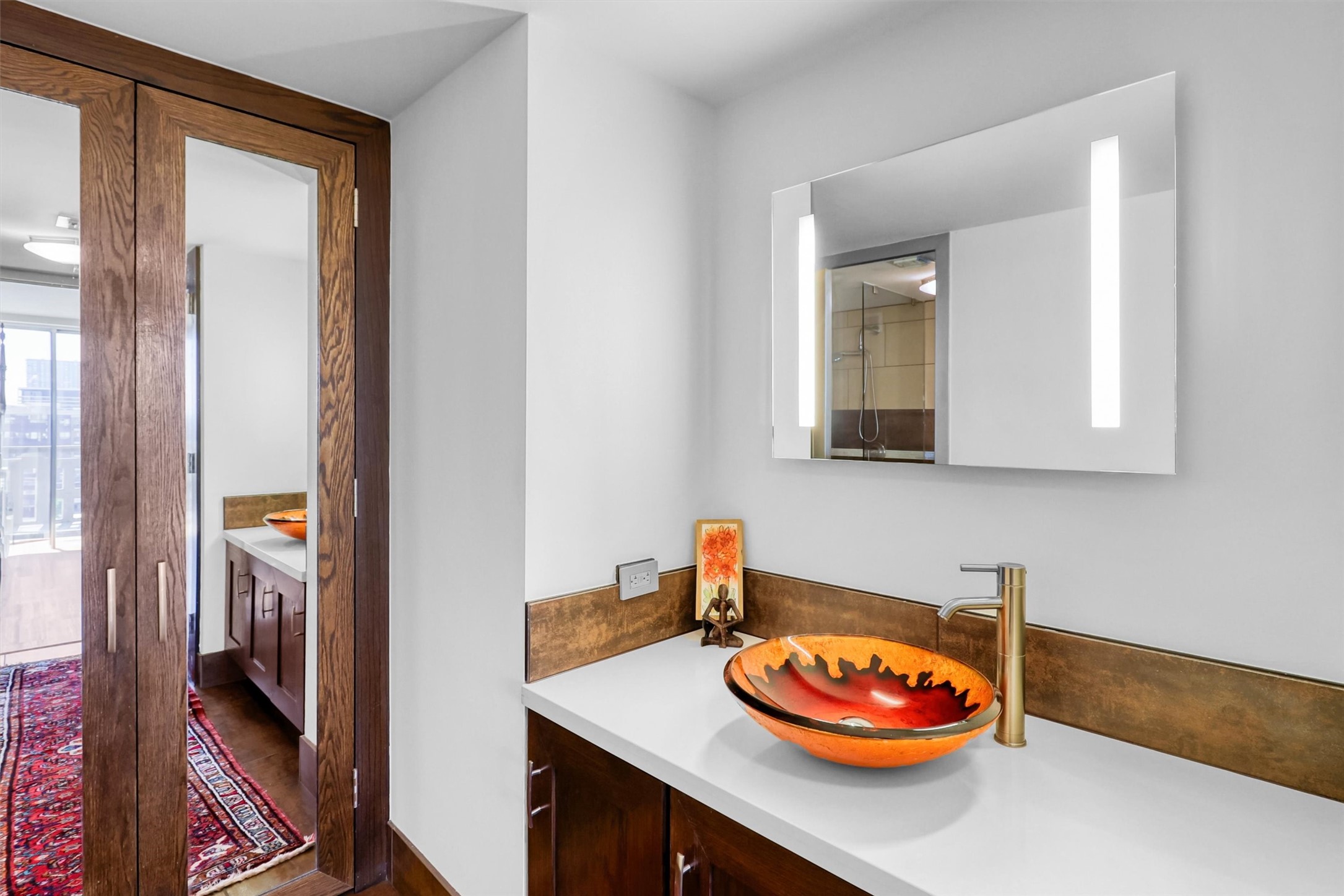 2016 Main Street, Unit 722 Houston, TX 77002 - Photo 30 of 38 a view of a bathroom with sink and a mirror