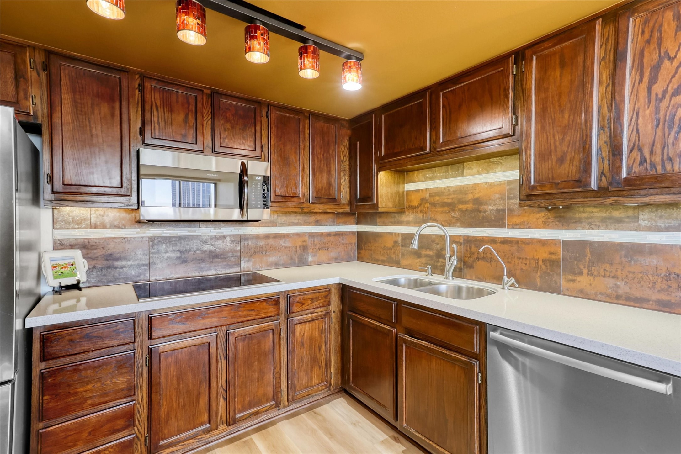 2016 Main Street, Unit 722 Houston, TX 77002 - Photo 8 of 38 a kitchen with stainless steel appliances granite countertop wooden cabinets a sink and dishwasher