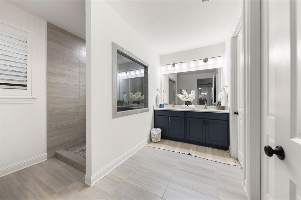1517 Miranda Lane Denton, TX 76210 - Photo 16 of 37 a bathroom with a sink and a mirror
