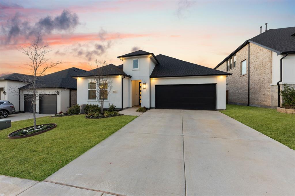 1517 Miranda Lane Denton, TX 76210 - Photo 3 of 37 a front view of a house with a garden and yard