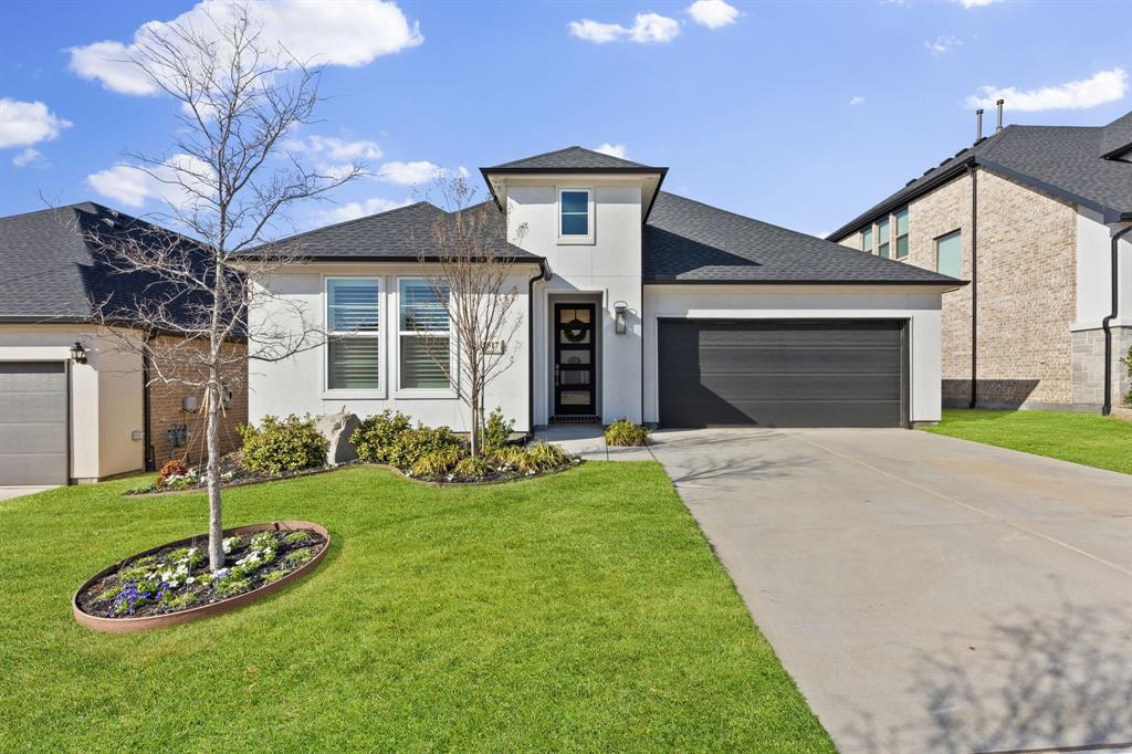 1517 Miranda Lane Denton, TX 76210 - Photo 4 of 37 a front view of a house with a yard and garage