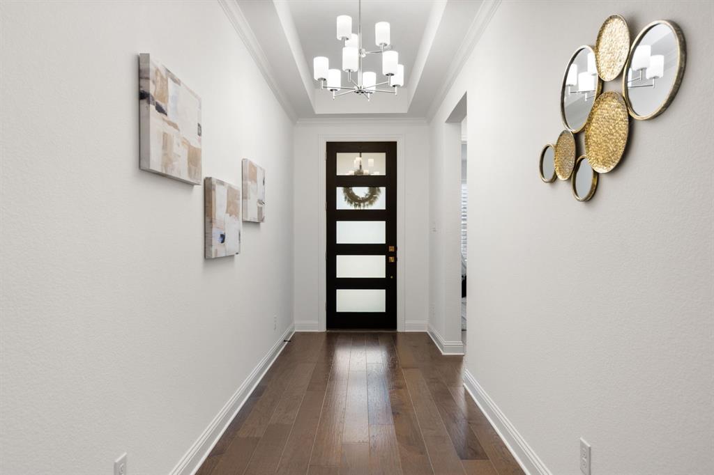 1517 Miranda Lane Denton, TX 76210 - Photo 5 of 37 a view of a hallway with wooden floor and staircase
