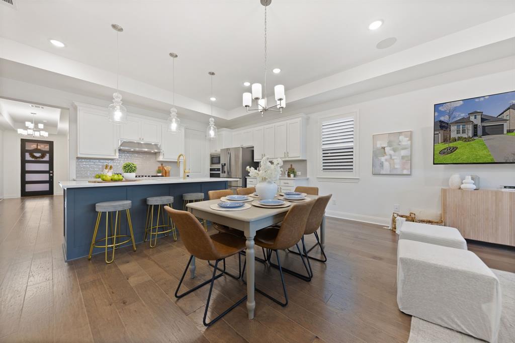 1517 Miranda Lane Denton, TX 76210 - Photo 8 of 37 a view of a dining room with furniture and wooden floor