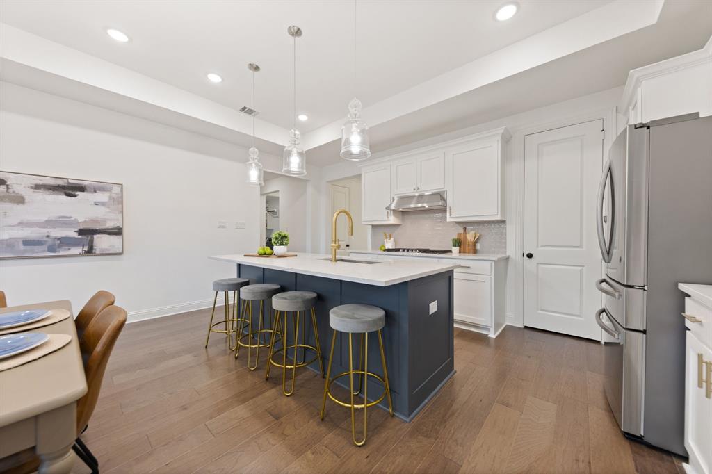 1517 Miranda Lane Denton, TX 76210 - Photo 9 of 37 a kitchen with granite countertop a table chairs stove a sink and a refrigerator