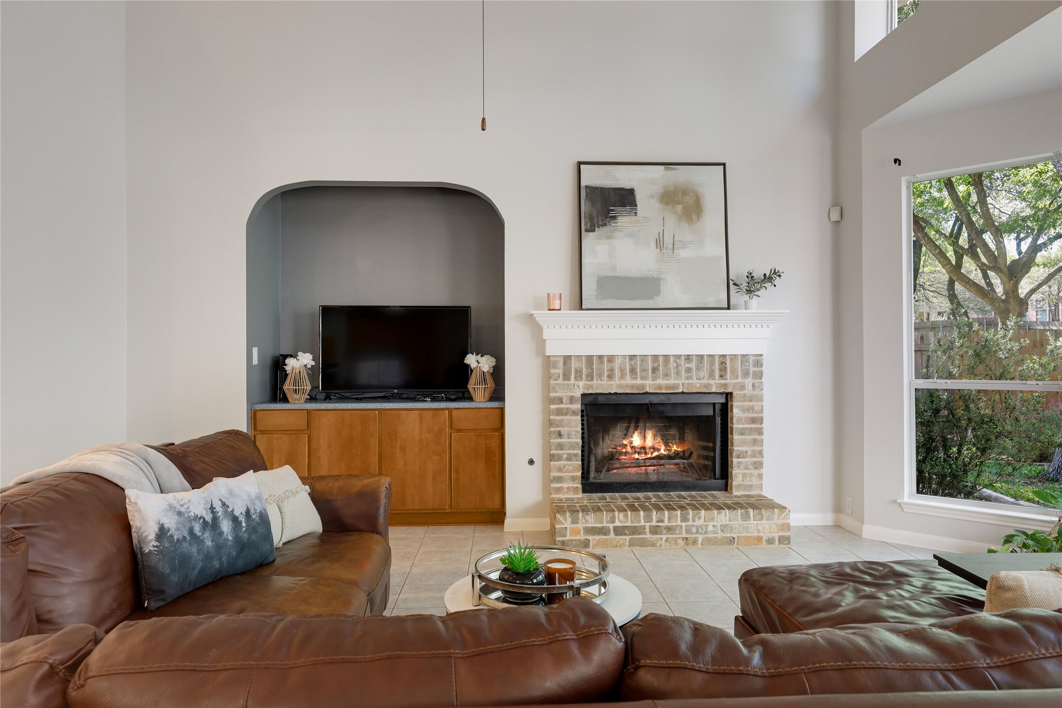 225 Trophy Pass Austin, TX 78748 - Photo 11 of 30 A cozy fireplace adds warmth to the inviting living room.