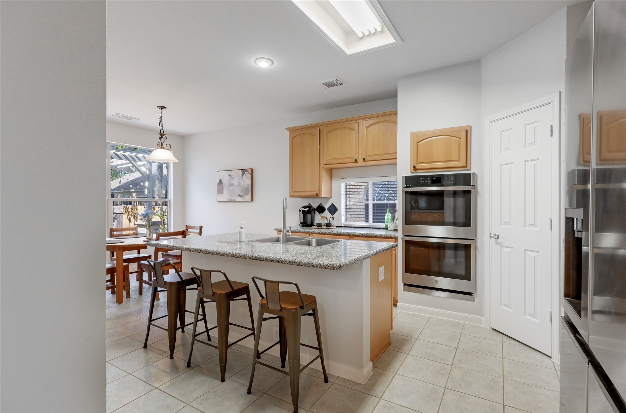 225 Trophy Pass Austin, TX 78748 - Photo 13 of 30 The island adds extra seating, extra prep space, and an easy spot for catching up at the end of the day.